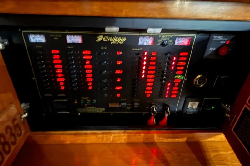 Slide: The Image of Electrical panel of 2004 Cruisers Yachts 405 Express Motoryacht with illuminated switches and gauges. - 37