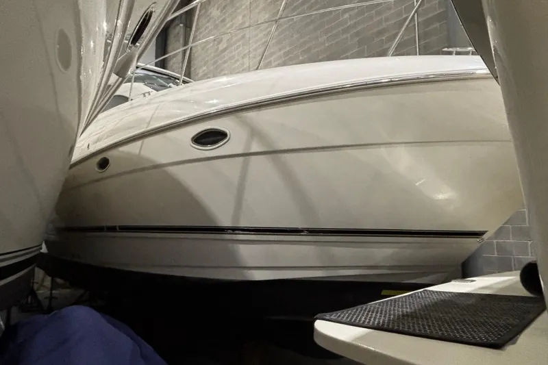 Slide: The Image of 2004 Cruisers Yachts 405 Express Motoryacht in storage, side view of sleek white hull. - 4