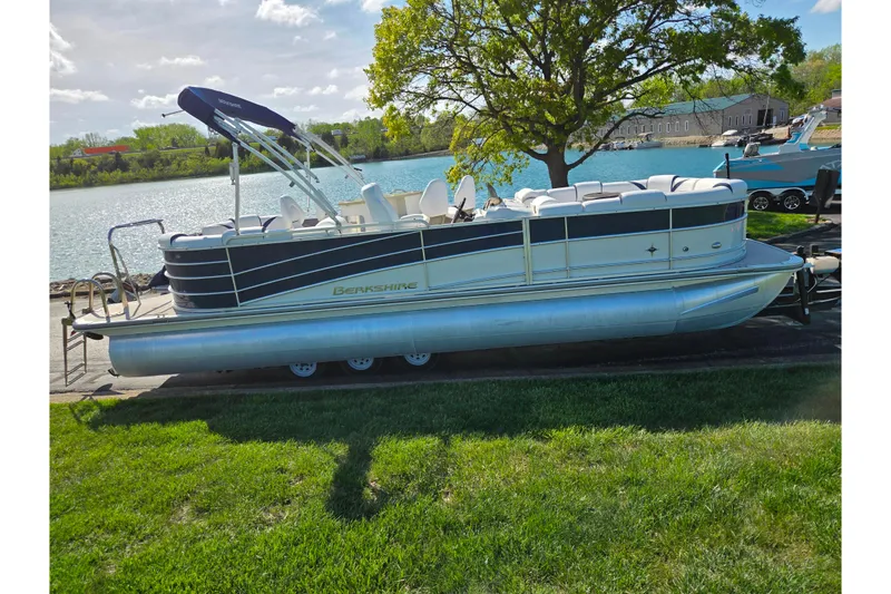 Slide: The Image of 2018 Berkshire 25E STS Entertainment pontoon boat by a scenic lake. - 10