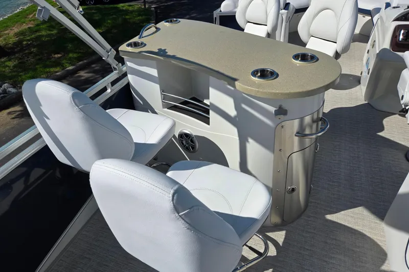 Slide: The Image of 2018 Berkshire 25E STS Entertainment boat interior with white seating and entertainment console. - 13