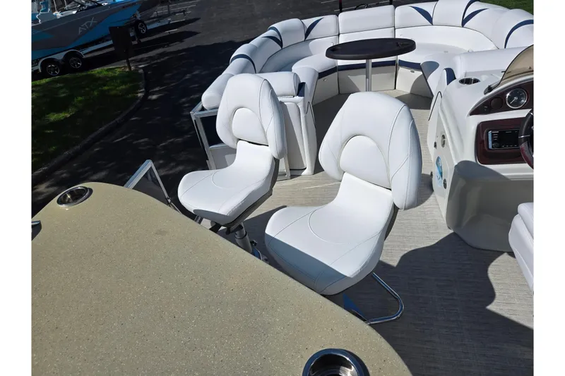 Slide: The Image of 2018 Berkshire 25E STS Entertainment pontoon boat with white seating and round table. - 15