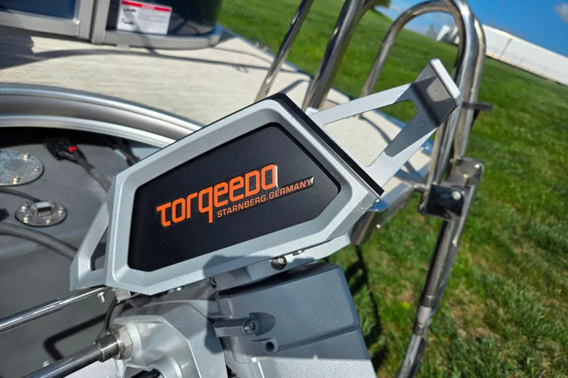 Slide: The Image of Torqeedo motor on 2018 Berkshire 25E STS Entertainment boat, outdoor setting. - 2