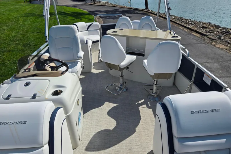 Slide: The Image of 2018 Berkshire 25E STS Entertainment pontoon boat with white seating and steering console. - 22