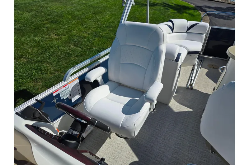 Slide: The Image of 2018 Berkshire 25E STS Entertainment boat interior with white captain's chair and seating. - 23