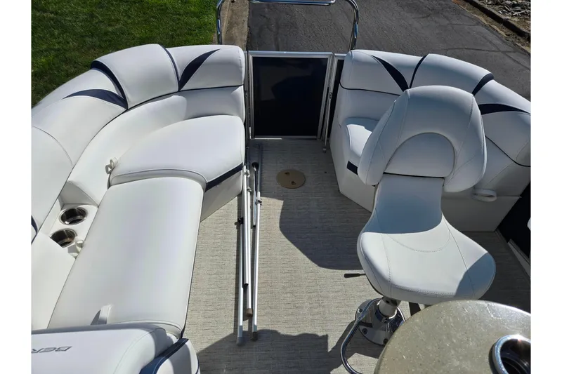 Slide: The Image of 2018 Berkshire 25E STS Entertainment boat interior with white seating and cup holders. - 25