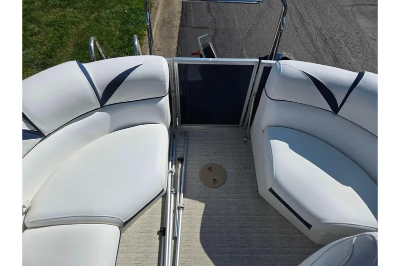 Slide: The Image of 2018 Berkshire 25E STS Entertainment boat interior with white cushioned seating and metal railings. - 26