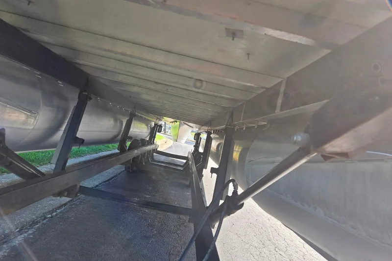 Slide: The Image of Underneath view of a 2018 Berkshire 25E STS Entertainment pontoon boat on a trailer. - 8