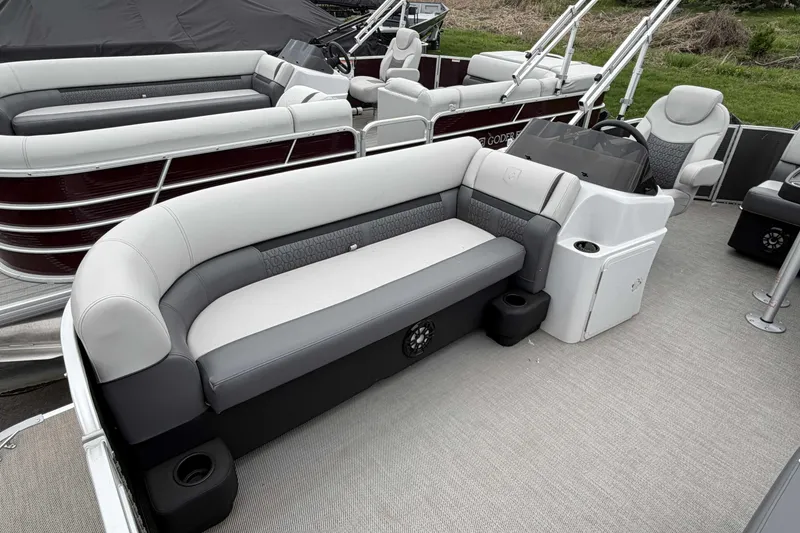 Slide: The Image of 2022 Godfrey Sweetwater 2086 C pontoon boat interior with plush seating and modern helm. - 10