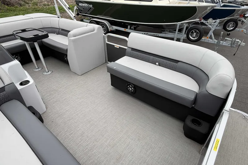 Slide: The Image of 2022 Godfrey Sweetwater 2086 C pontoon boat interior with gray seating and table. - 11
