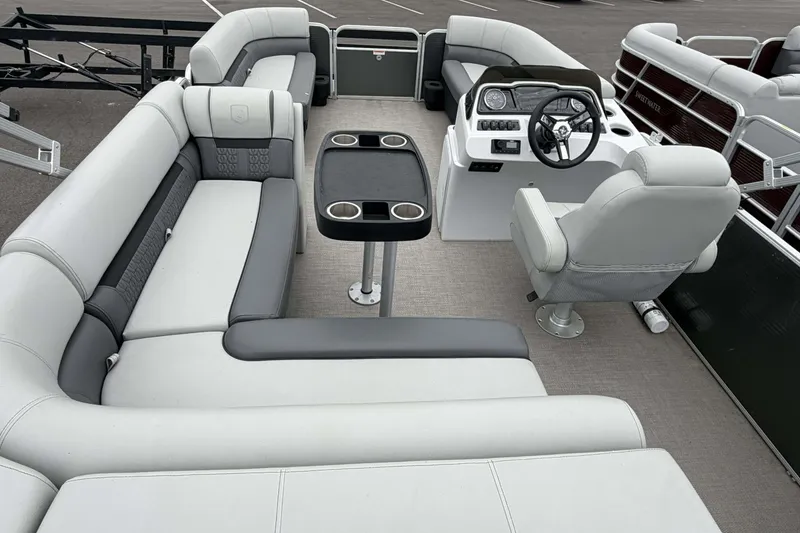 Slide: The Image of 2022 Godfrey Sweetwater 2086 C pontoon boat interior with plush seating and steering console. - 18