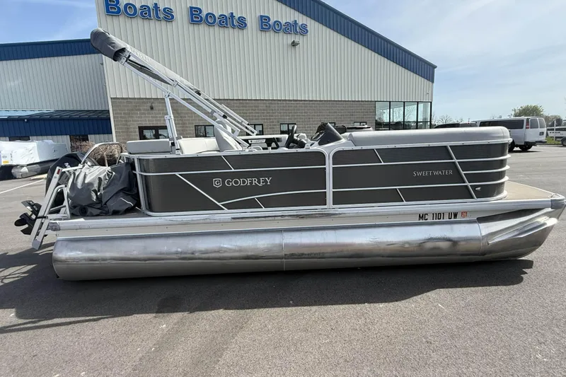 Slide: The Image of 2022 Godfrey Sweetwater 2086 C pontoon boat parked outside dealership. - 2