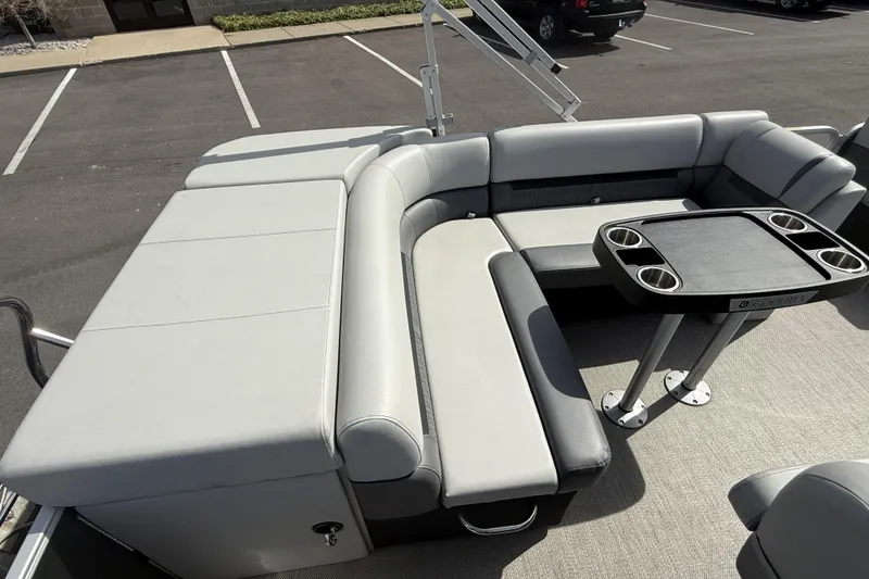Slide: The Image of 2022 Godfrey Sweetwater 2086 C pontoon boat interior with cushioned seating and table. - 20