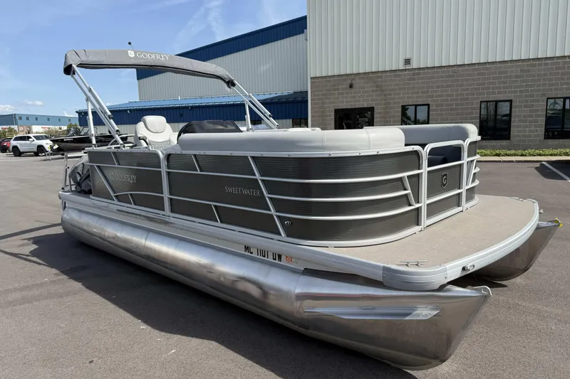 Slide: The Image of 2022 Godfrey Sweetwater 2086 C pontoon boat parked outside industrial building. - 4