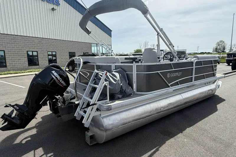 Slide: The Image of 2022 Godfrey Sweetwater 2086 C pontoon boat with Mercury engine, parked outside a building. - 6