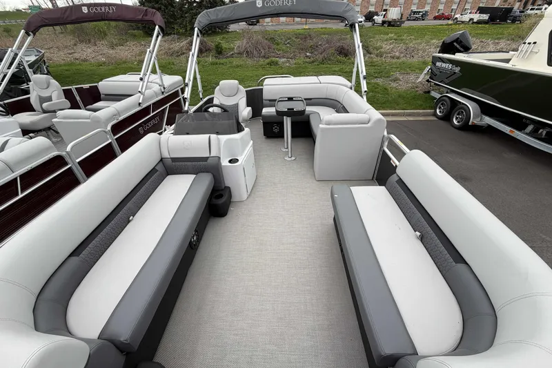 Slide: The Image of 2022 Godfrey Sweetwater 2086 C pontoon boat interior with spacious seating and helm. - 8