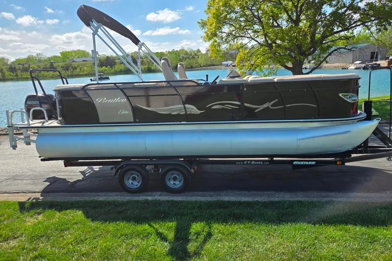The Image of 2017 Bentley Pontoons 220 Elite Admiral on trailer by a lake. - 0