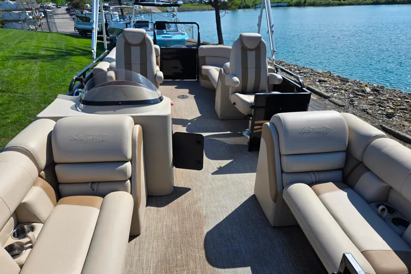 Slide: The Image of 2017 Bentley Pontoons 220 Elite Admiral with luxurious seating by a serene lake. - 11