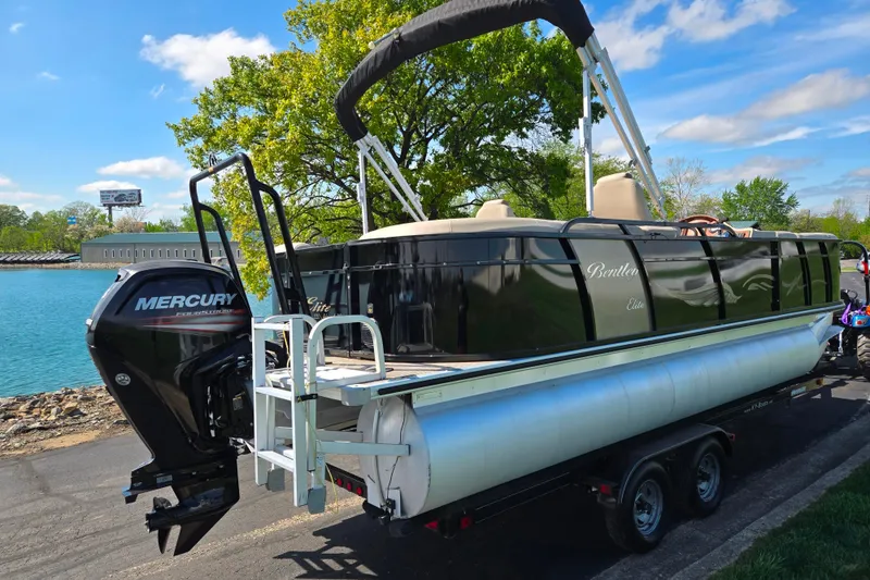 Slide: The Image of 2017 Bentley Pontoons 220 Elite Admiral on trailer by a scenic waterfront. - 2