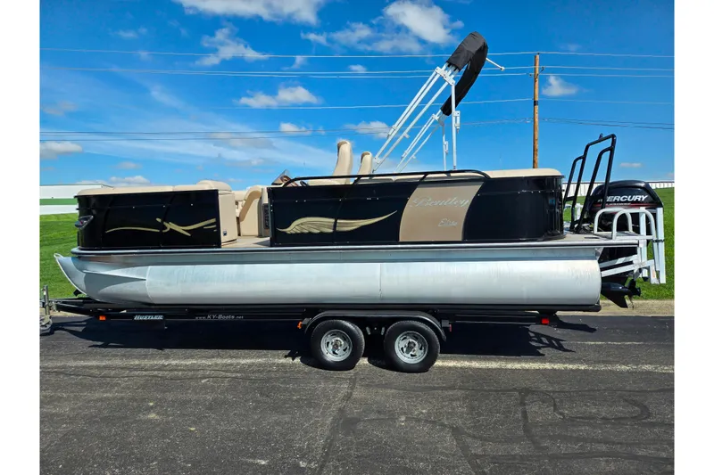 Slide: The Image of 2017 Bentley Pontoons 220 Elite Admiral on trailer, featuring sleek design and Mercury outboard motor. - 5