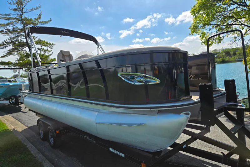 Slide: The Image of 2017 Bentley Pontoons 220 Elite Admiral on trailer by a lake. - 9
