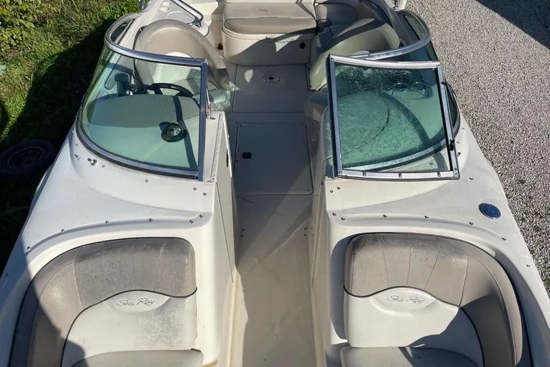 Slide: The Image of 2004 Sea Ray 240 Sundeck boat interior with seating and windshield. - 12