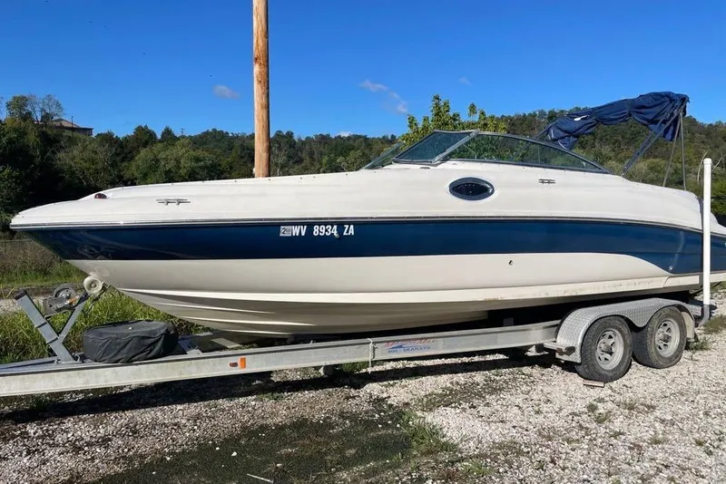 Slide: The Image of 2004 Sea Ray 240 Sundeck boat on trailer, parked outdoors. - 13