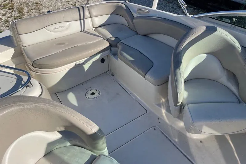Slide: The Image of 2004 Sea Ray 240 Sundeck interior with spacious seating and elegant design. - 4
