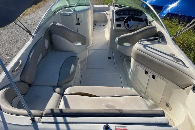 Slide: The Image of 2004 Sea Ray 240 Sundeck interior with seating and steering wheel, showing wear. - 6