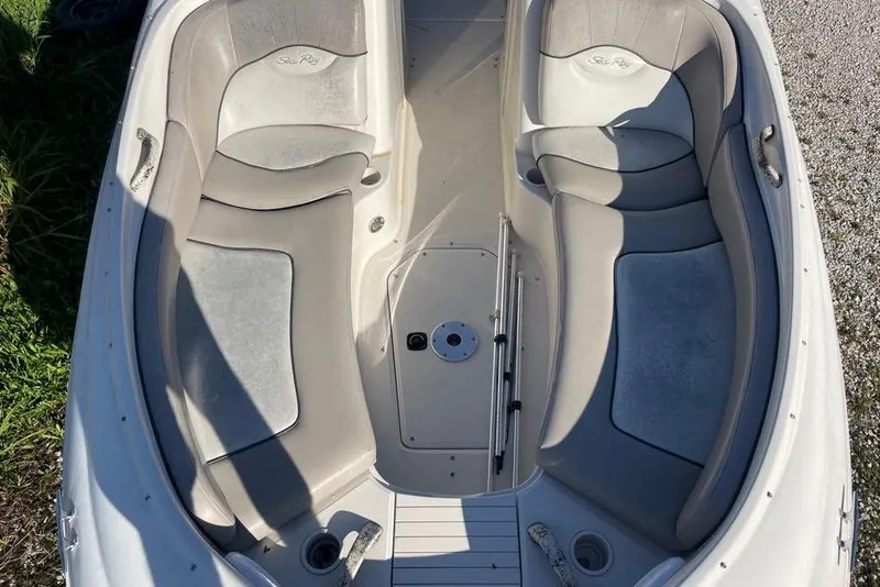 Slide: The Image of 2004 Sea Ray 240 Sundeck boat interior with spacious seating and cup holders. - 7