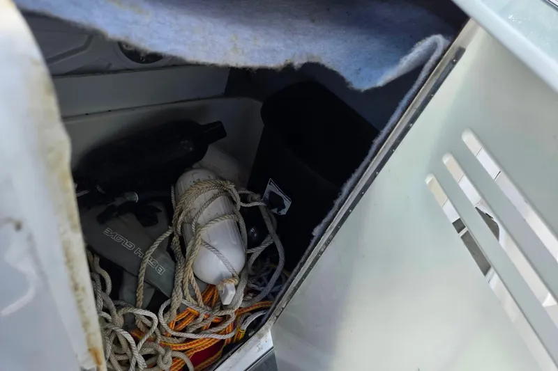 Slide: The Image of Storage compartment in 2007 Yamaha SX230 HO boat with ropes and equipment. - 15