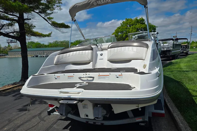 Slide: The Image of 2007 Yamaha Boats SX230 HO on trailer by lakeside, under blue sky. - 2