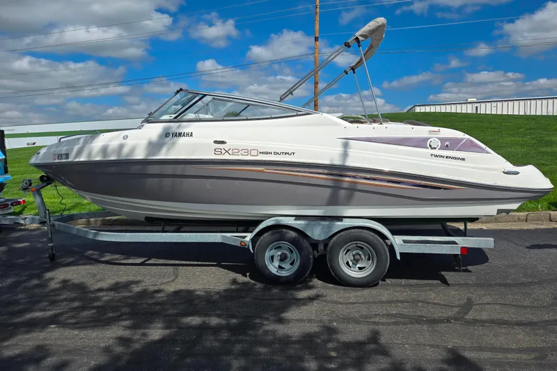 Slide: The Image of 2007 Yamaha Boats SX230 HO on trailer, parked outdoors under a blue sky. - 4