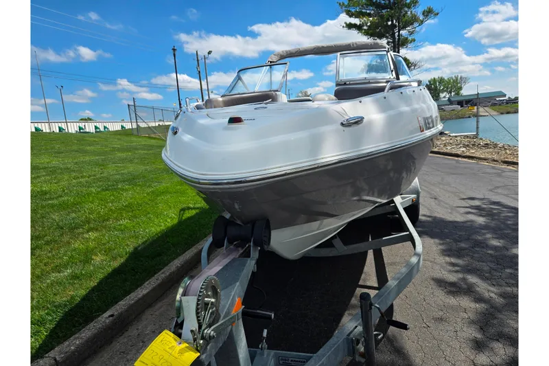 Slide: The Image of 2007 Yamaha Boats SX230 HO on trailer, parked near a grassy area under a blue sky. - 6
