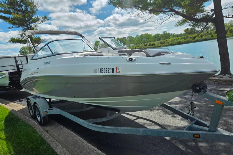 Slide: The Image of 2007 Yamaha Boats SX230 HO on trailer by a scenic lake. - 8