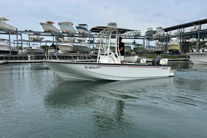 The Image of 2022 Boston Whaler 190 Montauk boat in marina, surrounded by docked vessels. - 0