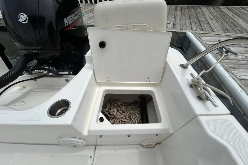 Slide: The Image of 2022 Boston Whaler 190 Montauk boat with open storage compartment and Mercury engine. - 10