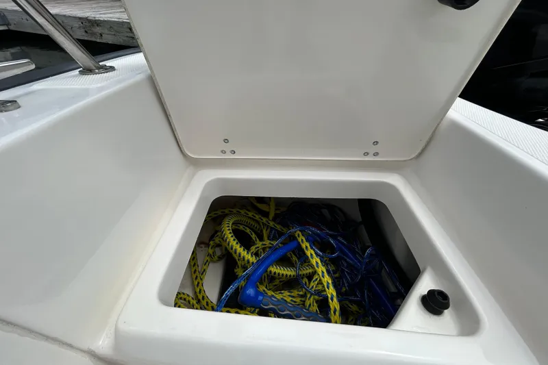 Slide: The Image of Open storage compartment on 2022 Boston Whaler 190 Montauk boat with ropes inside. - 11