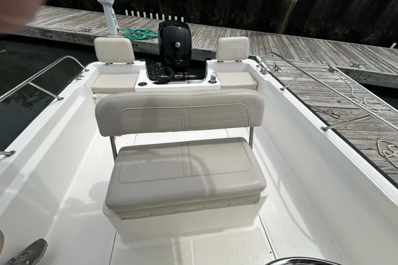Slide: The Image of 2022 Boston Whaler 190 Montauk boat interior with seating and steering console. - 14