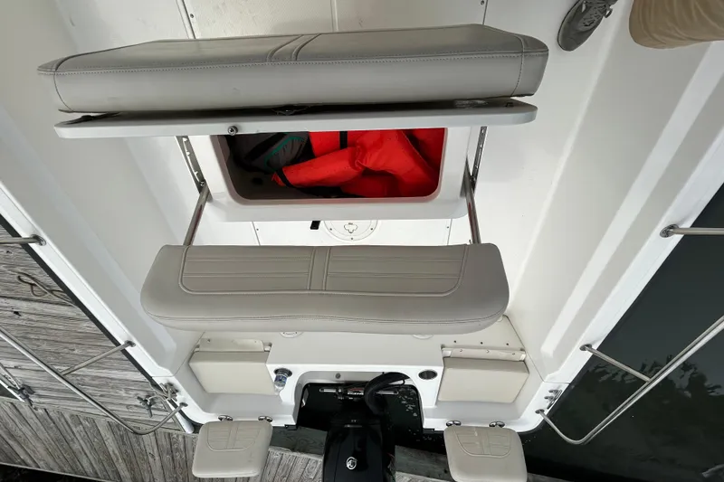 Slide: The Image of 2022 Boston Whaler 190 Montauk boat interior with storage compartment and seating. - 15