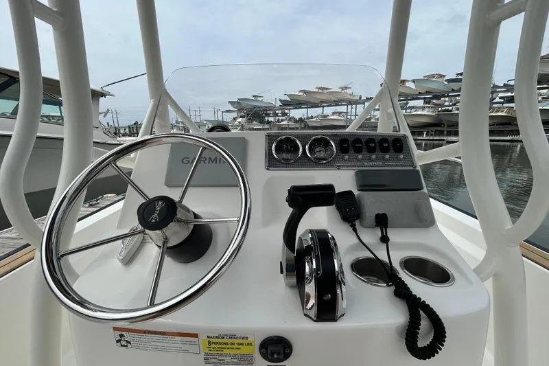 Slide: The Image of 2022 Boston Whaler 190 Montauk boat console with steering wheel and controls. - 17