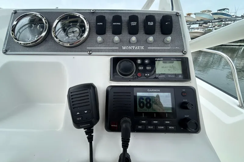 Slide: The Image of Control panel of a 2022 Boston Whaler 190 Montauk boat with navigation instruments. - 18