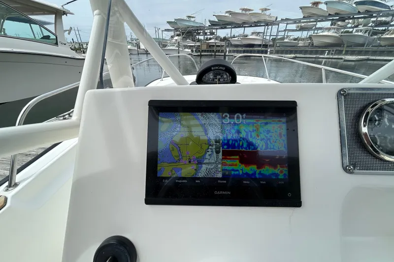 Slide: The Image of Boston Whaler 190 Montauk 2022 boat dashboard with Garmin navigation display. - 19