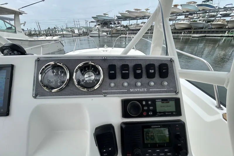 Slide: The Image of Dashboard of a 2022 Boston Whaler 190 Montauk boat with gauges and controls. - 21