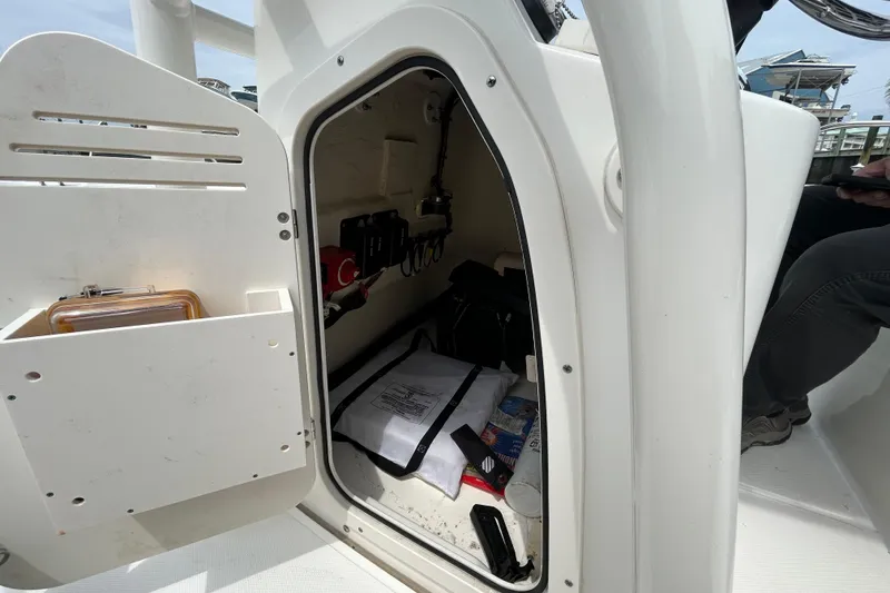 Slide: The Image of Storage compartment of a 2022 Boston Whaler 190 Montauk boat, showing interior equipment. - 24