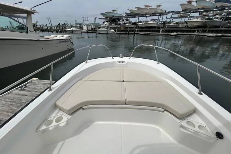 Slide: The Image of 2022 Boston Whaler 190 Montauk boat with cushioned seating, docked at marina. - 26