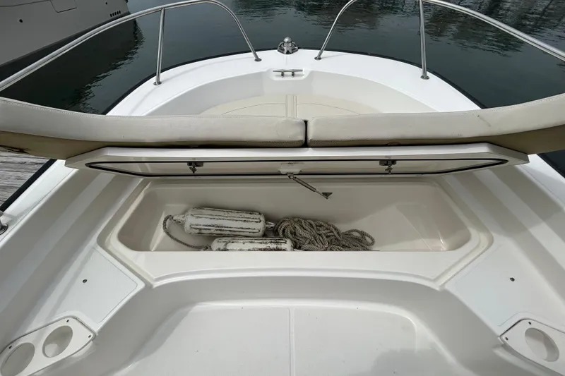 Slide: The Image of 2022 Boston Whaler 190 Montauk boat storage compartment with ropes and fenders. - 27