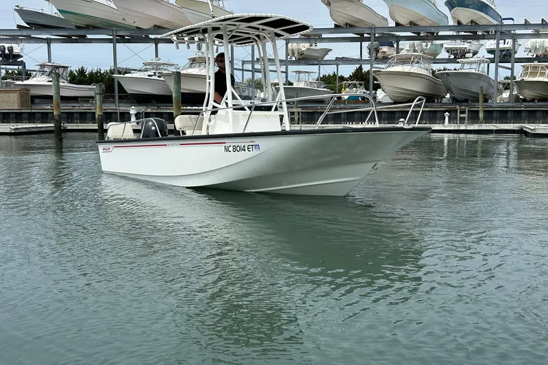 Slide: The Image of 2022 Boston Whaler 190 Montauk boat docked in marina with multiple boats in background. - 3
