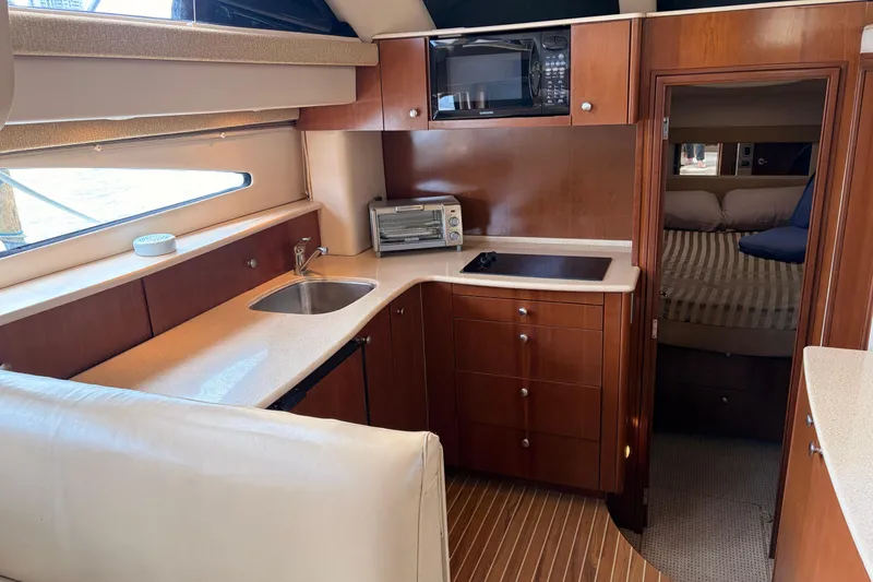 Slide: The Image of 2005 Meridian 368 Motoryacht interior with kitchenette and cozy cabin. - 12