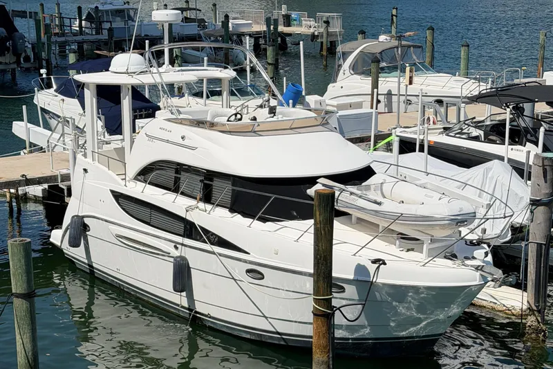 Slide: The Image of 2005 Meridian 368 Motoryacht docked at marina, featuring sleek design and spacious deck. - 2