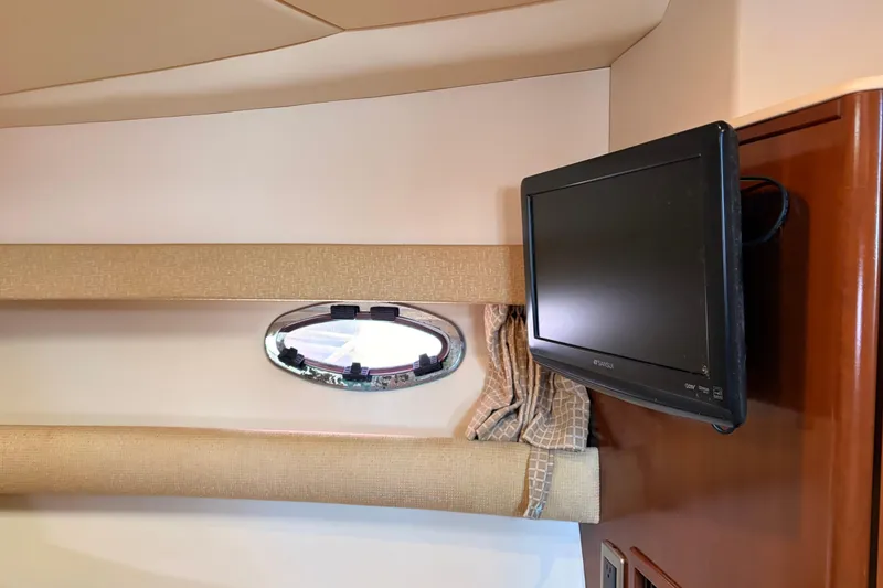 Slide: The Image of Interior of 2005 Meridian 368 Motoryacht with wall-mounted TV and porthole window. - 28
